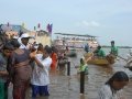 3rd shift volunteers helping elderly people water at Gowthami ghat