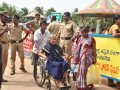 Volunteers taking elderly on wheel chair from Kailasa bhoomi to Gowthami ghat, Rajahmundry on 20th Jul 2015, 7th day of Godavari Pushkaralu