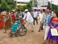 Volunteer assisting elderly with wheel chair  at Gowthami ghat, Rajahmundry on  23 Jul 2015, 10th day of Godavari Pushkaralu