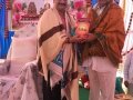 Sathguru Dr.Umar Alisha presenting Tatwajnanam magazine to Guest Sri MVVS Murthy garu, MLC (VSK) at Bheemili Ashram, 16th Anniversary Sabha
